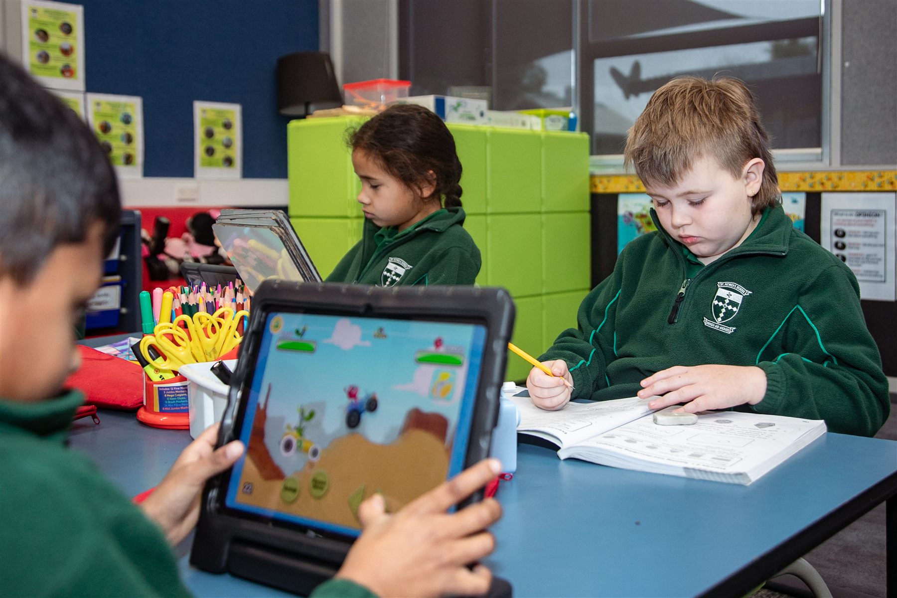 A St Patrick's student playing a learning game on a tablet in class