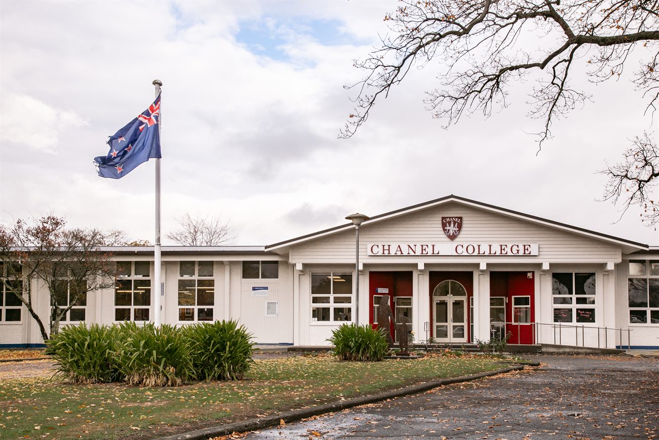 The front entrance of Chanel College in Masterton, with the New Zealand flag flying
