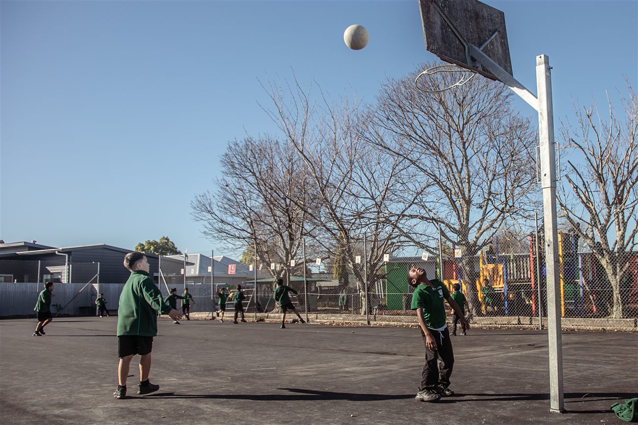 St Patrick's students playing basketball on the school court