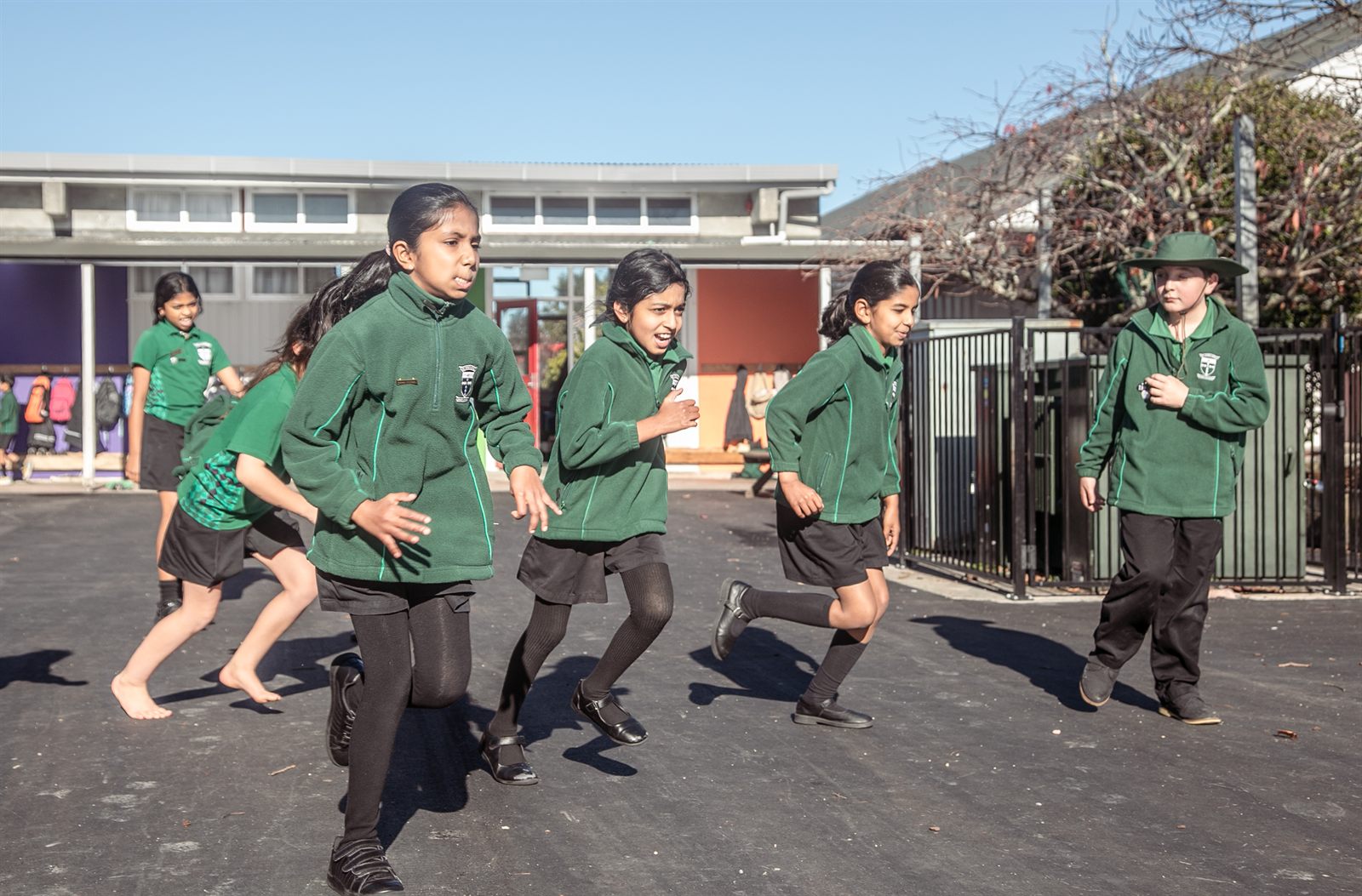 St Patrick's students running across the school courtyard together