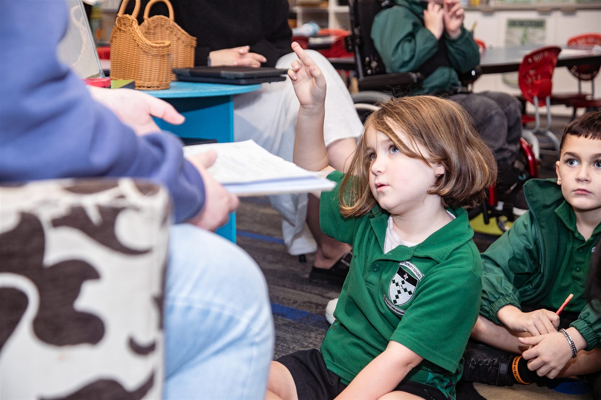A St Patrick's student raising her hand to ask a question during a class discussion