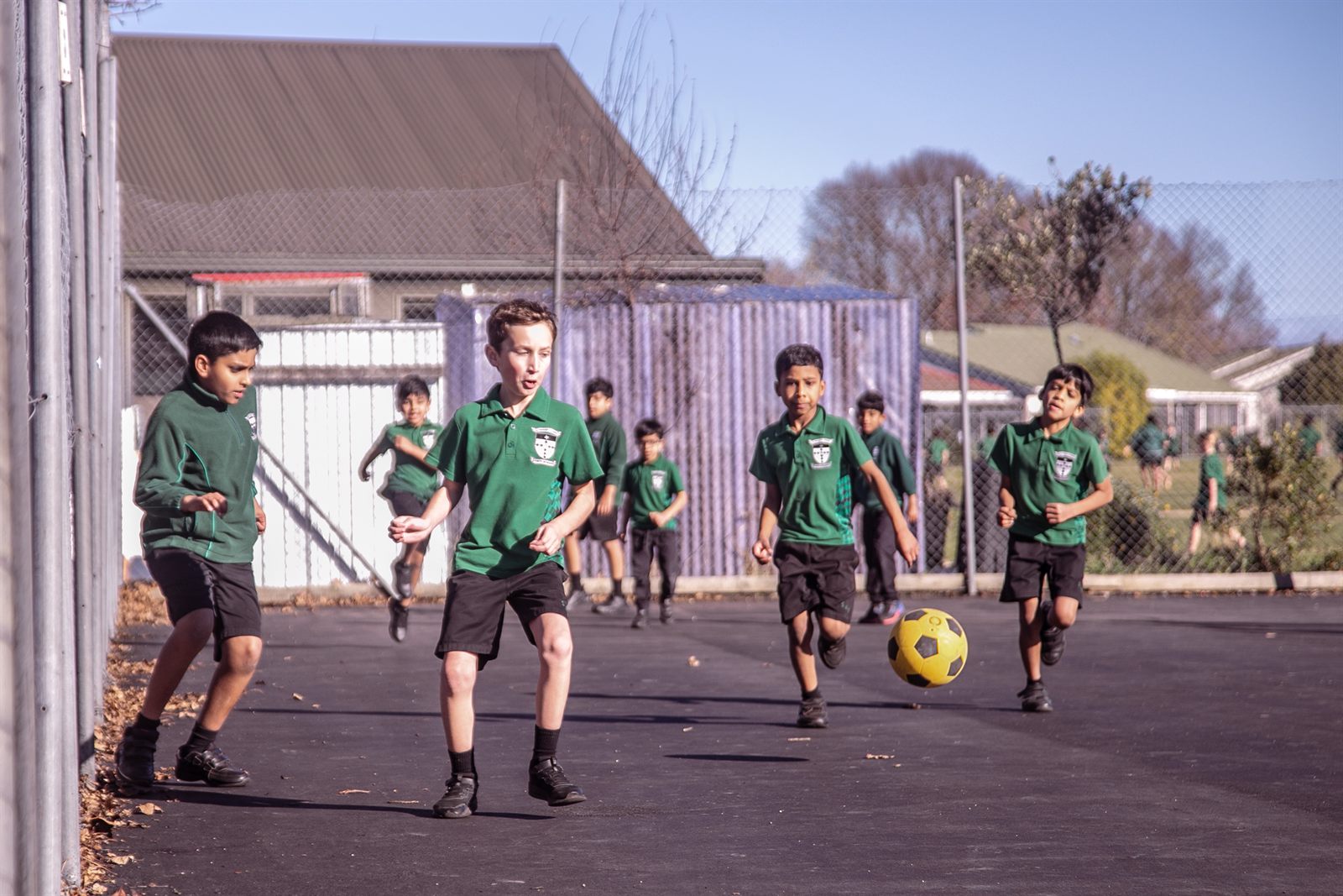 St Patrick's students playing football on the school court