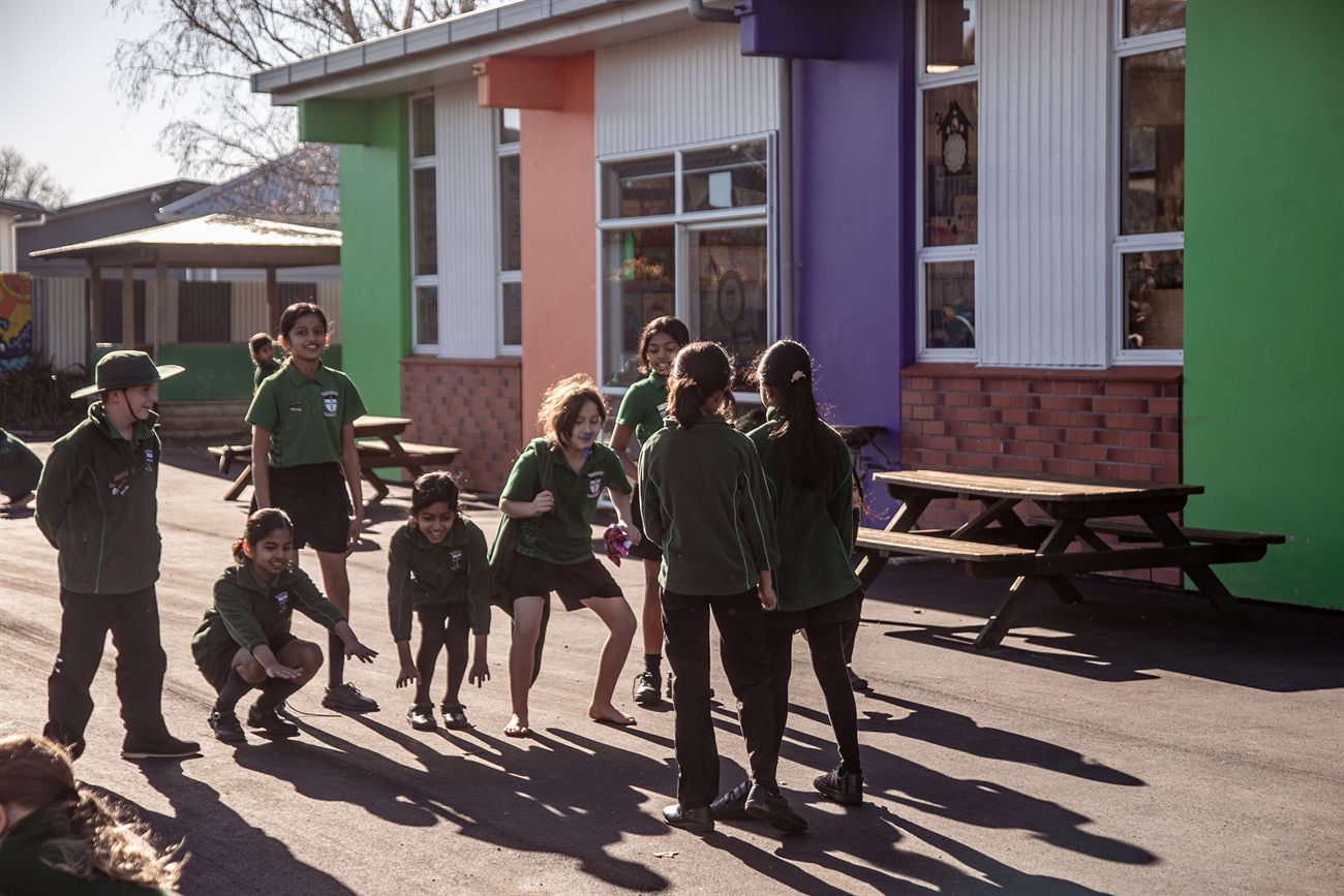 St Patrick's students playing together in the school courtyard in the afternoon sun