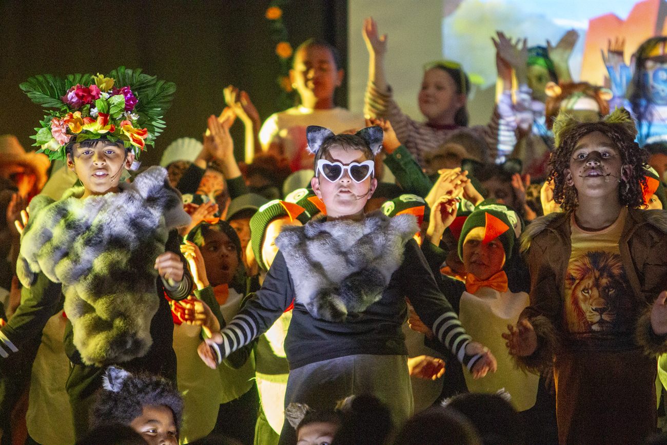 St Patrick’s students in animal costumes performing on stage in the school production